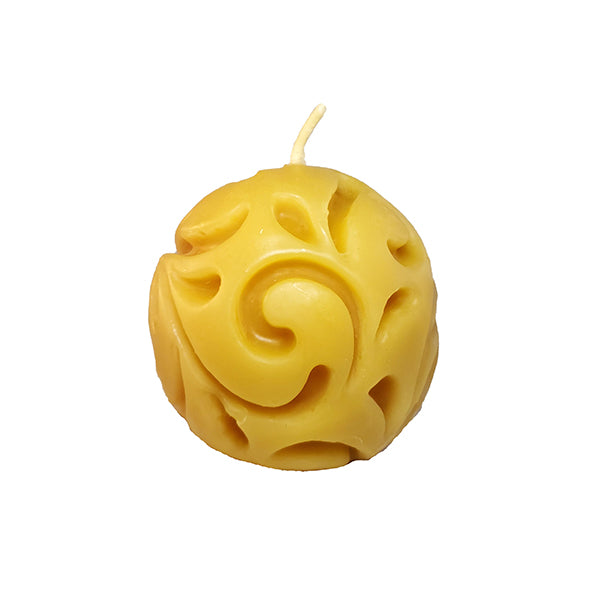 Round beeswax candle with carved design