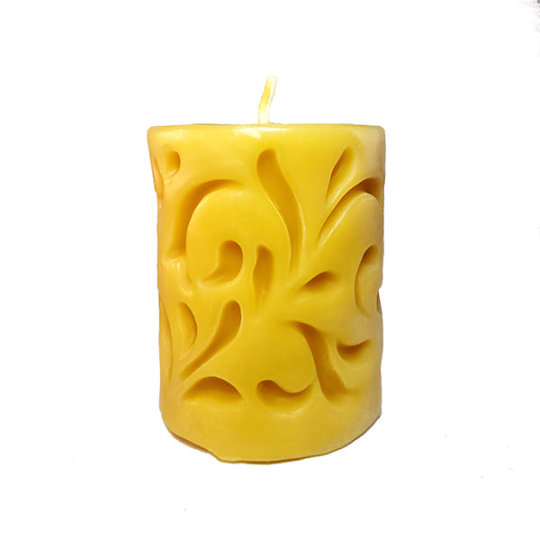 Beeswax candle with carved filigree design