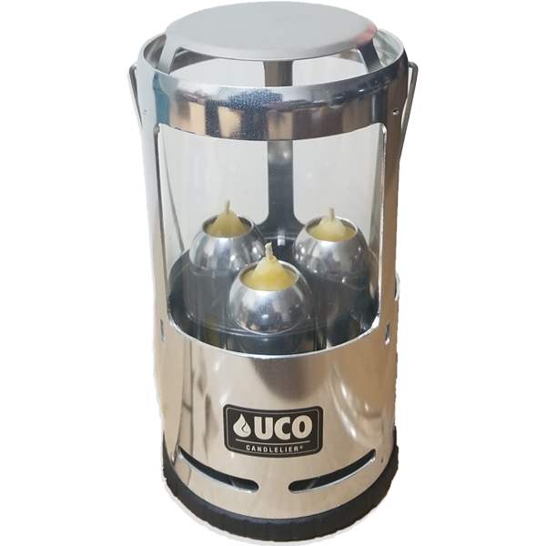 Silver UCO camping lantern with three beeswax candles inside